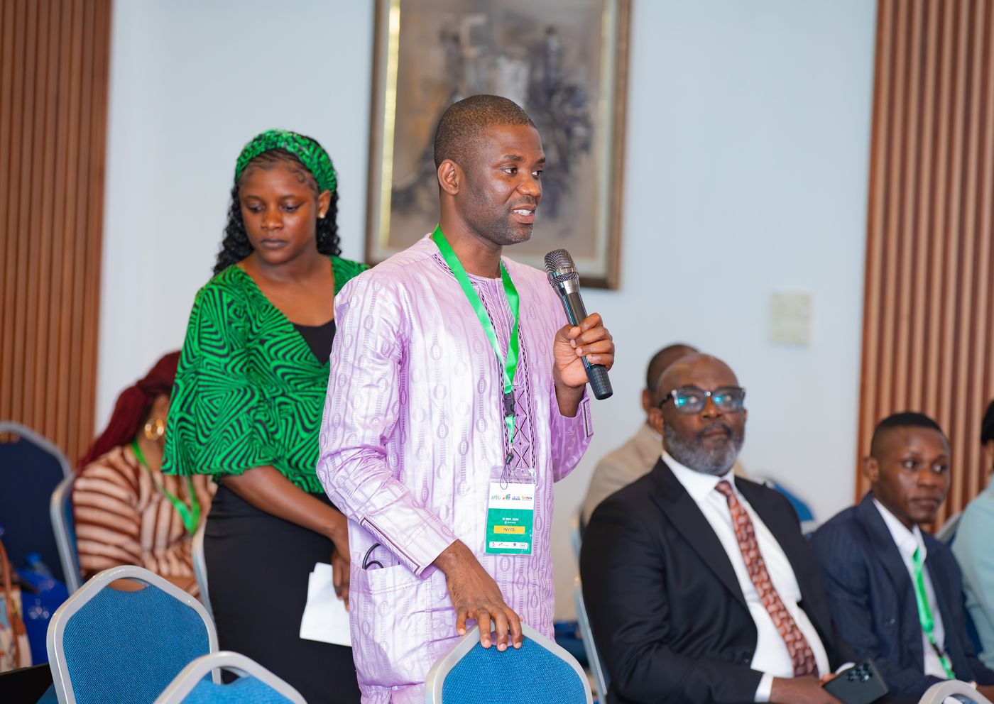 A delegate speaking from the floor with a microphone