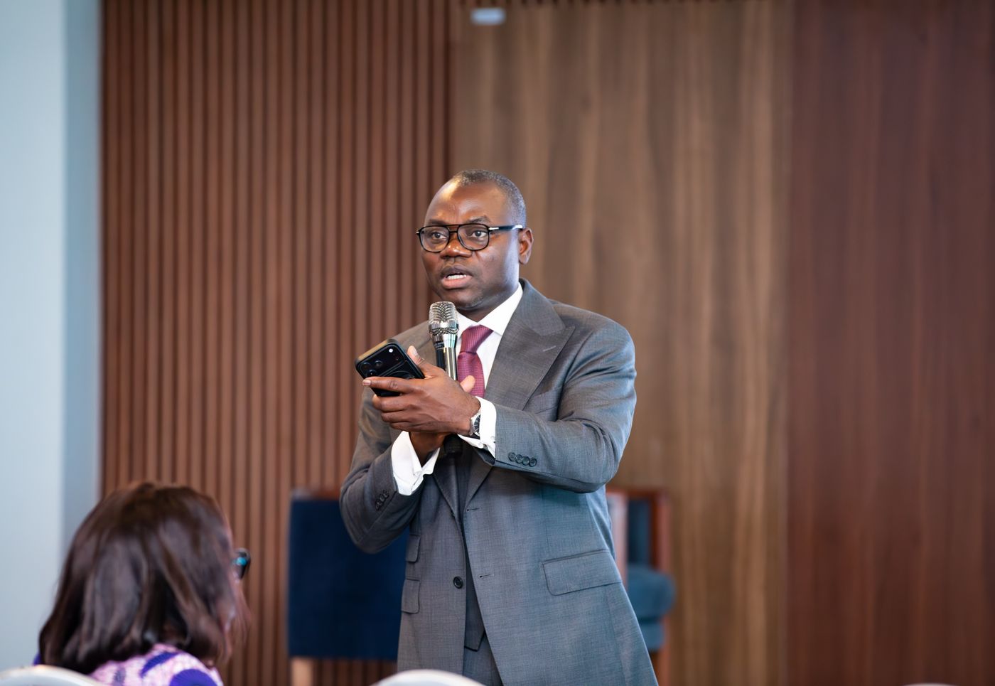 Speaker with a microphone addressing Benin Deal Room 2026